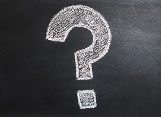 Question mark written in chalk on black board