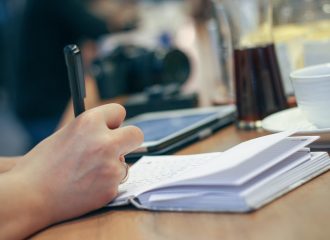 Person writing on notebook to illustrate how IFAs work