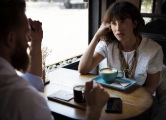 Man and woman chatting over coffee to illustrate what a Relevant Life Plan is