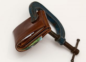 Wallet held in a vice to illustrate income protection