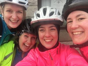 Selfie of Alice, Katie, Kate and Jenna wearing cycling helmets during cycling weekend away