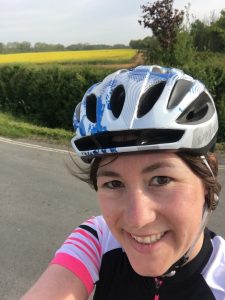 Head shot of Alice wearing a cycling helmet