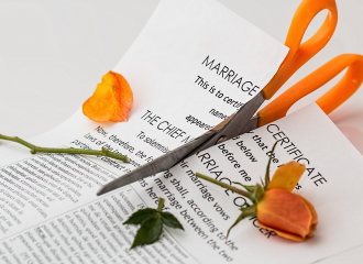 Cutting a marriage certificate with yellow scissors - yellow rose