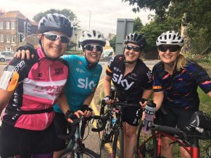 4 female cyclists in cycling gear at start of a ride