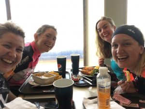 4 happy female cyclists enjoying lunch on board the ferry to France