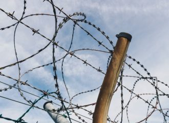 Barbwire along the top of a fence