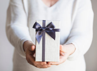 Lady holding out a gift