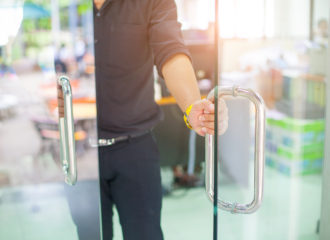 man walking through glass door