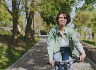 Smiling woman riding a bike