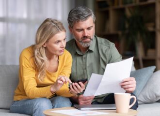 Middle-aged couple planning budget together